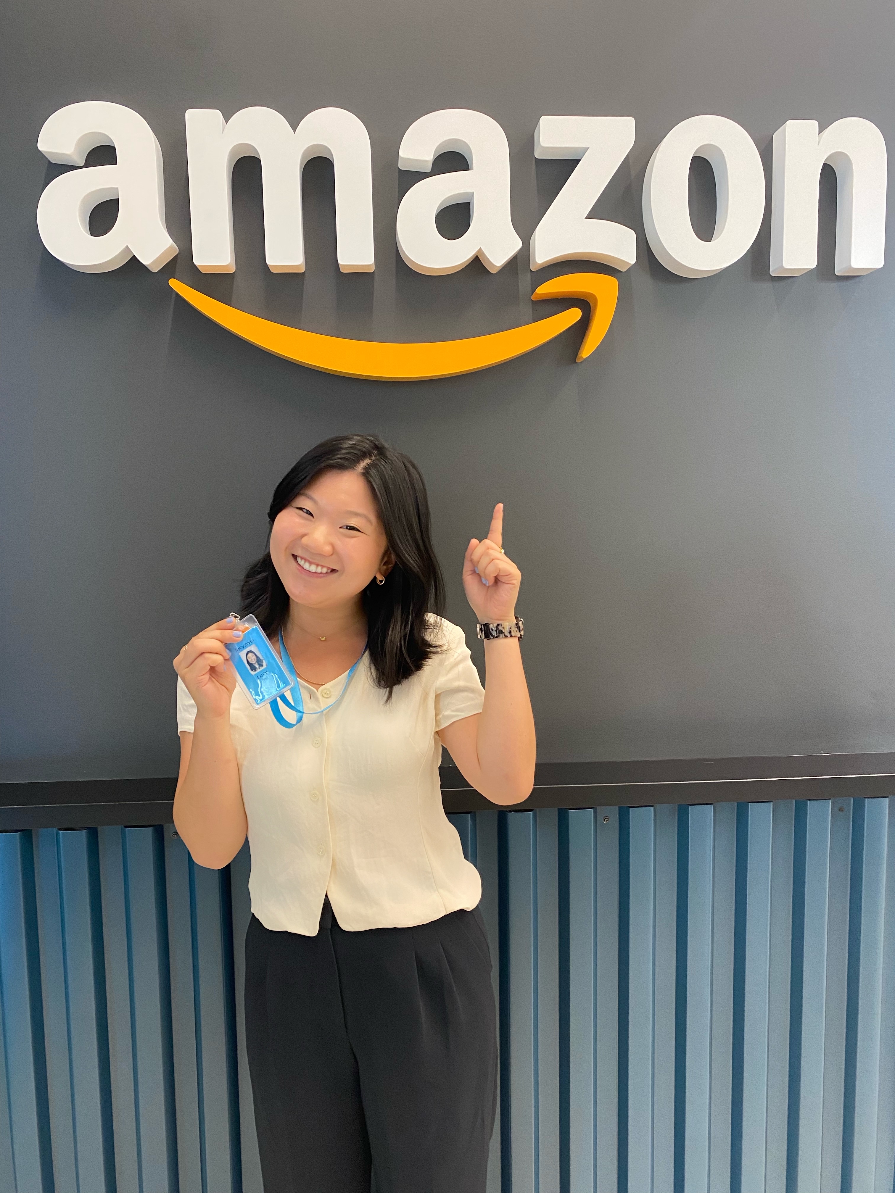 Lucy Wei in front of Amazon logo