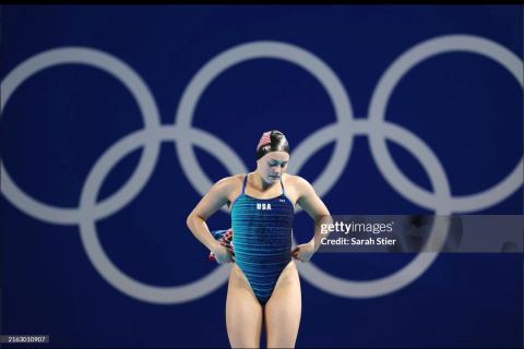 Alison Gibson ready to swim, with Olympic rings behind her
