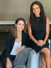 Two women sitting on a couch