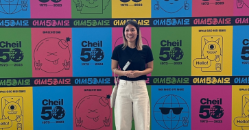 Sieun Ha standing in front of a wall of posters