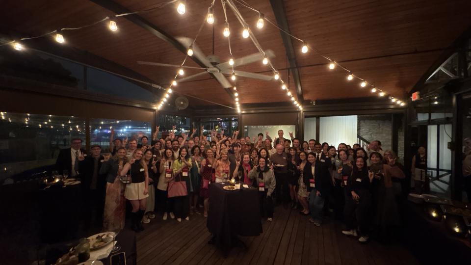 group photo of everyone doing Hook 'em