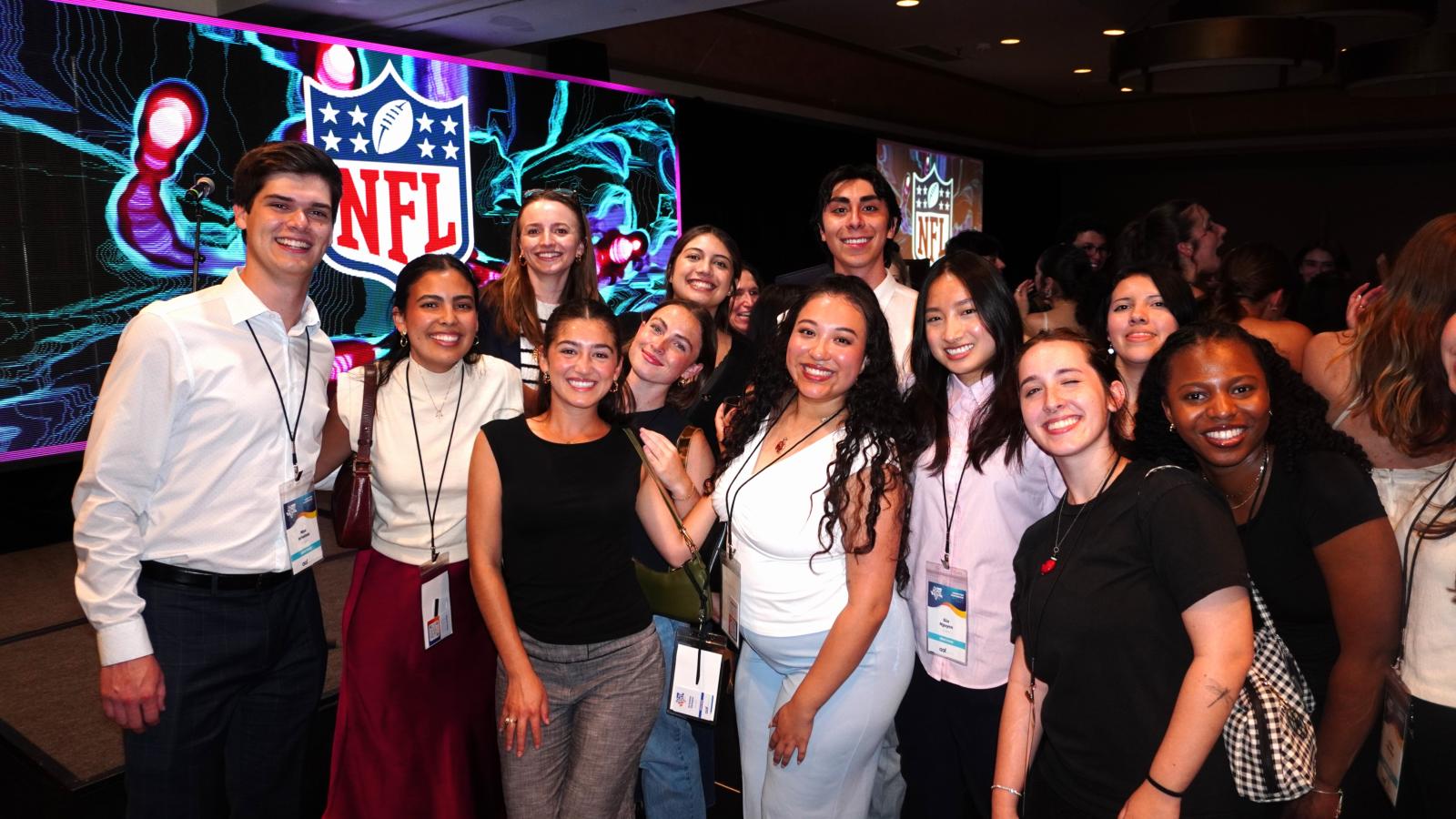 group of NSAC students with NFL logo in back