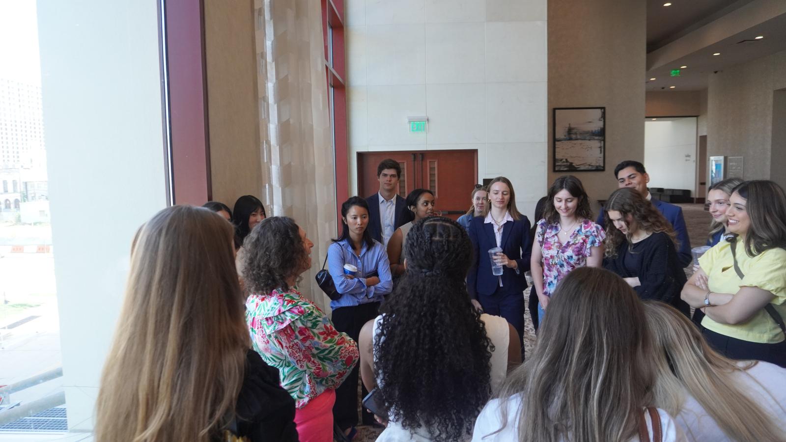 NSAC students group together to talk with Professor Lewis