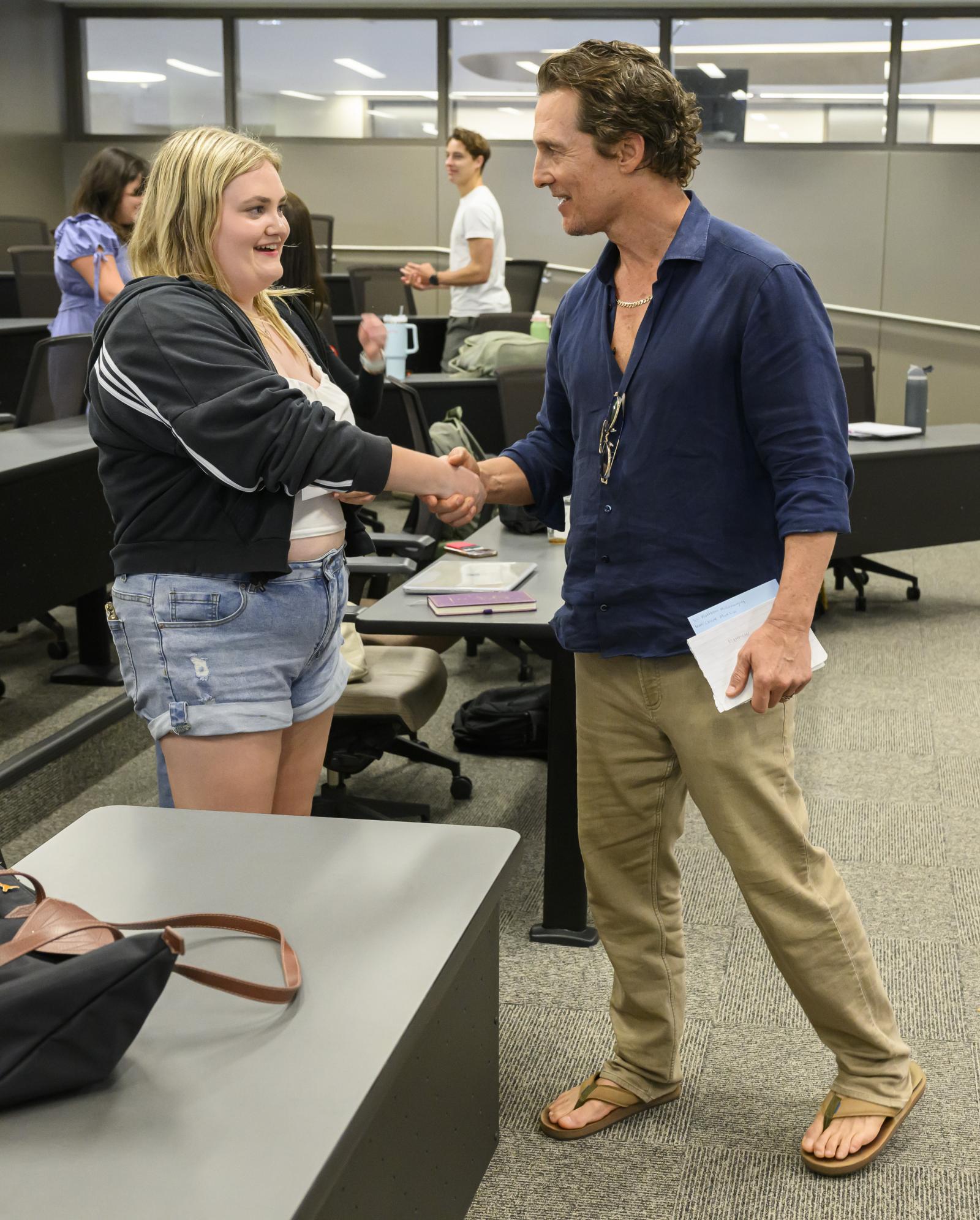 Student Rye Minka shakes hands with Matthew McConaughey