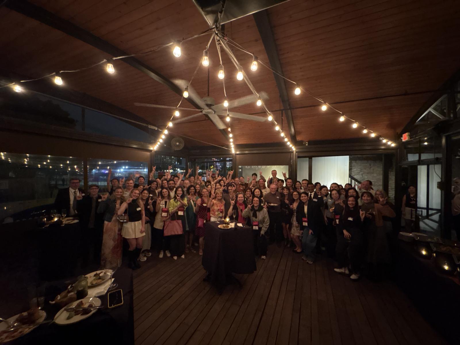group photo of everyone doing Hook 'em