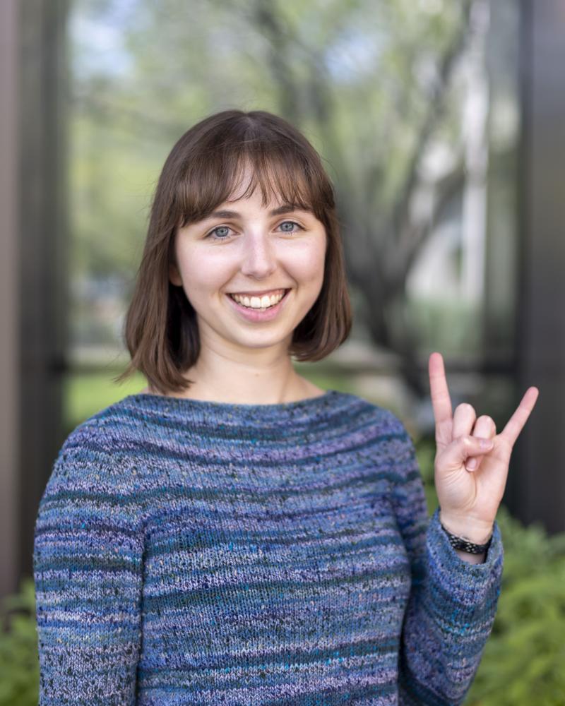 headshot of Jordan Kriseman doing hook'em handsign 